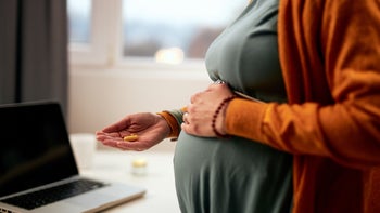 Pregnant: Antidepression: pregnant belly hand holding pill 1191716909