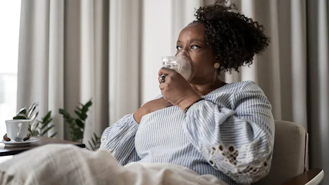 Pneumonia: woman using nebulizer 1309471810