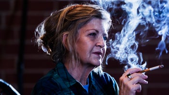 Breast-cancer: senior woman smoking a cigarette 920518848