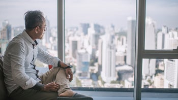 Finasteride: Post-Finasteride syndrome: looking out window city view 1325578137
