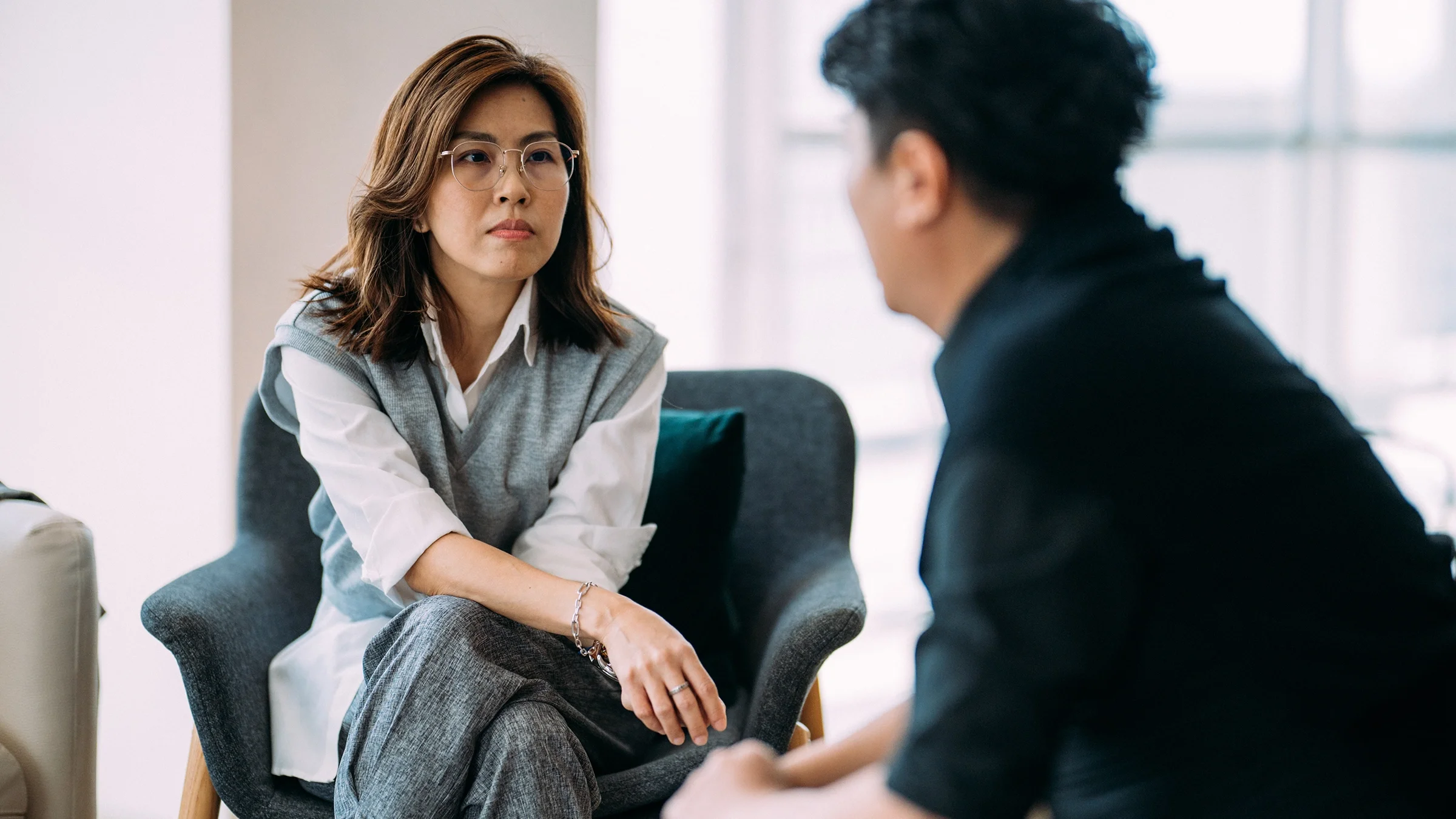 A therapist listens to a client during a one-on-one session.