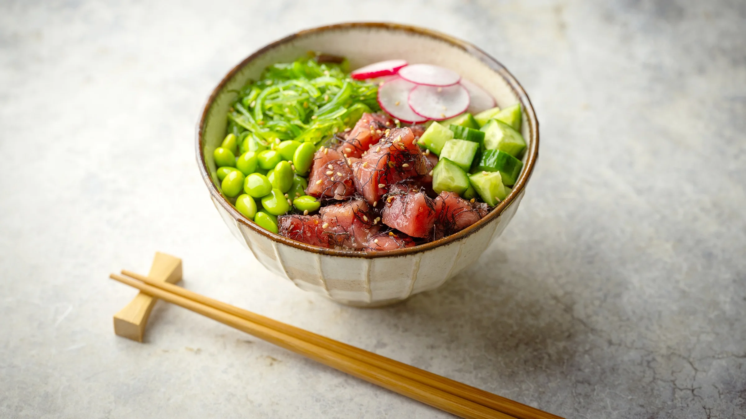 Hawaiian tuna poke rice bowl on table surface