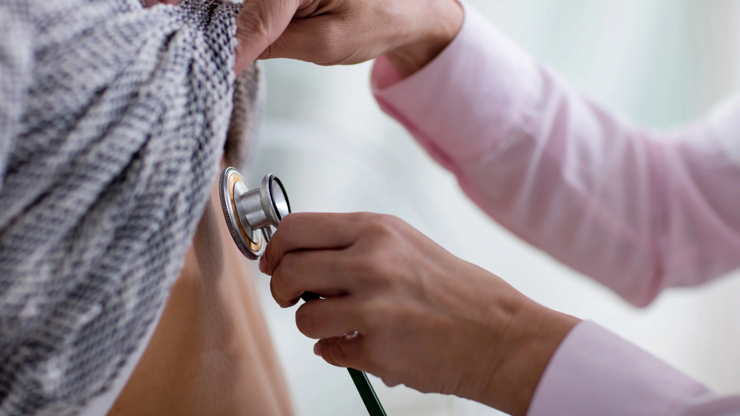 Close-up of a stethoscope on someone's back.