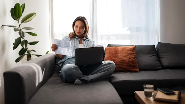 Insurance: woman reviewing paperwork 2181212248