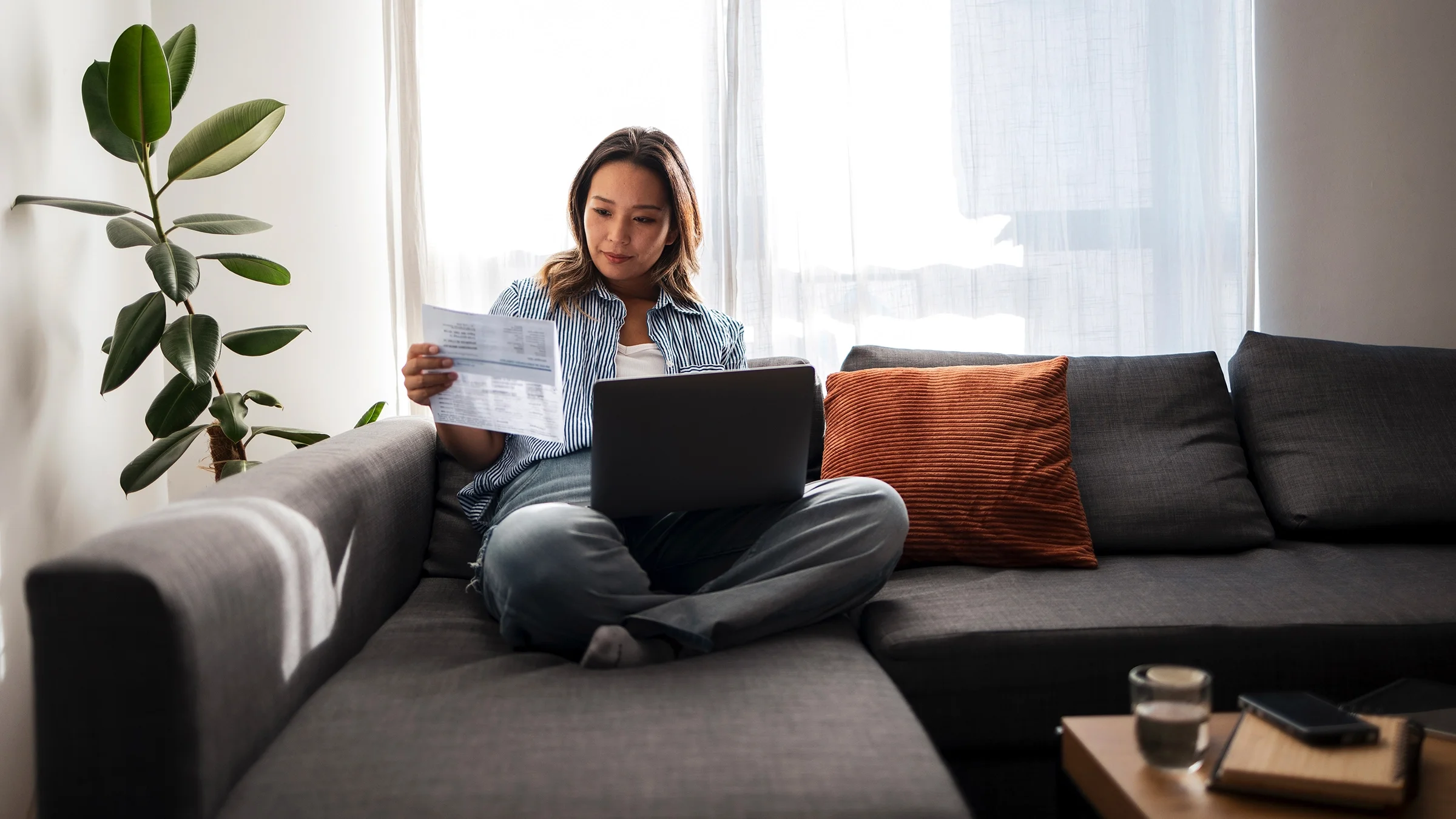 A woman reviews healthcare documents.