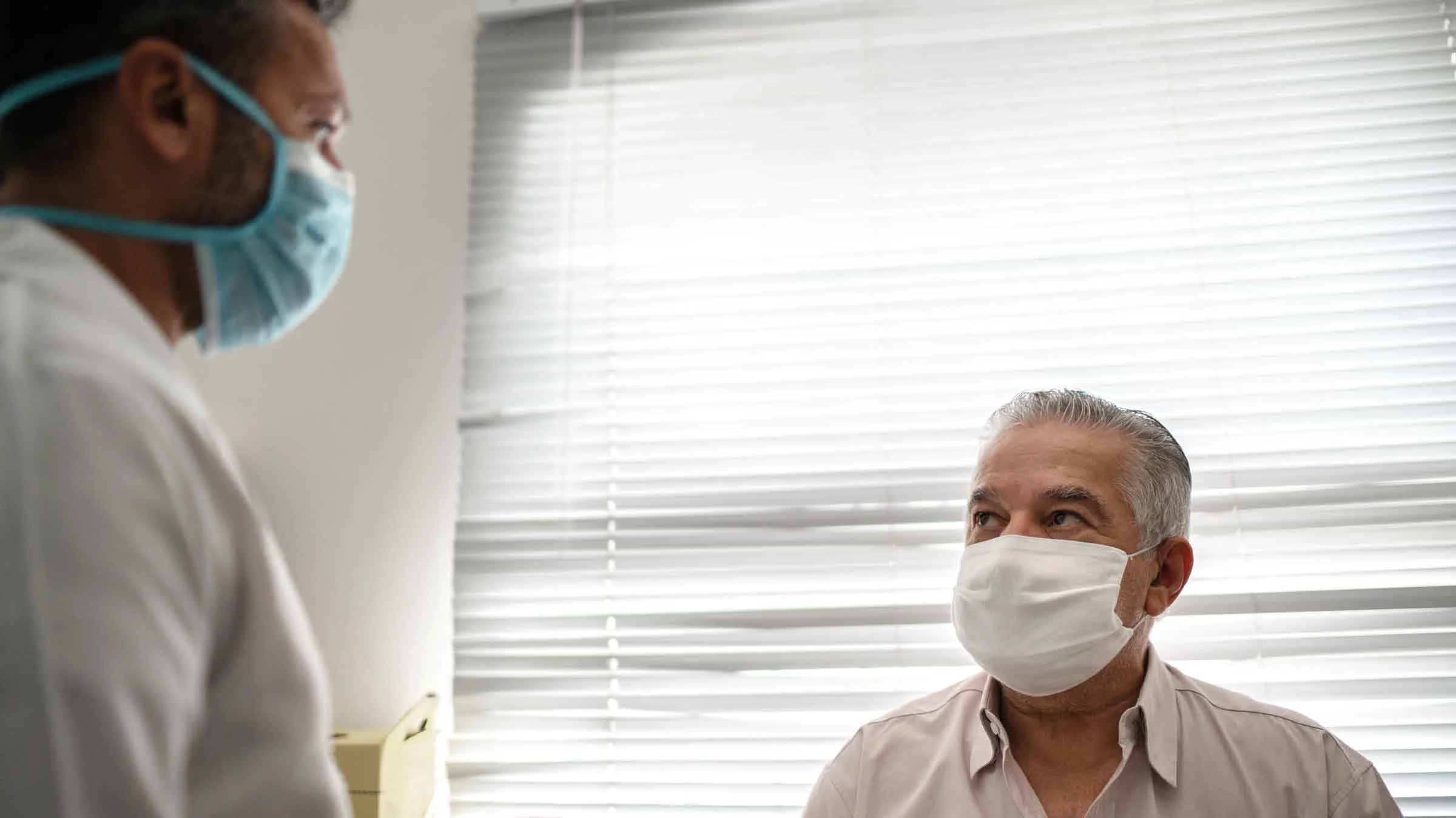 Patient in a medical consult wearing face mask