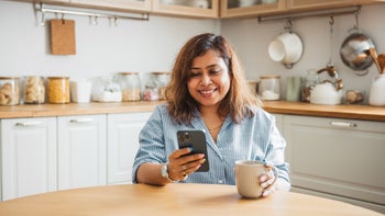 Diet-nutrition: woman drinking coffee using smart phone 2160305401