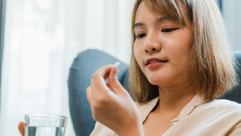 Health: Infections: woman taking pill with water 1427834489