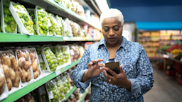 Woman using her smart phone at the supermarket.
FG Trade/E+ via Getty Images