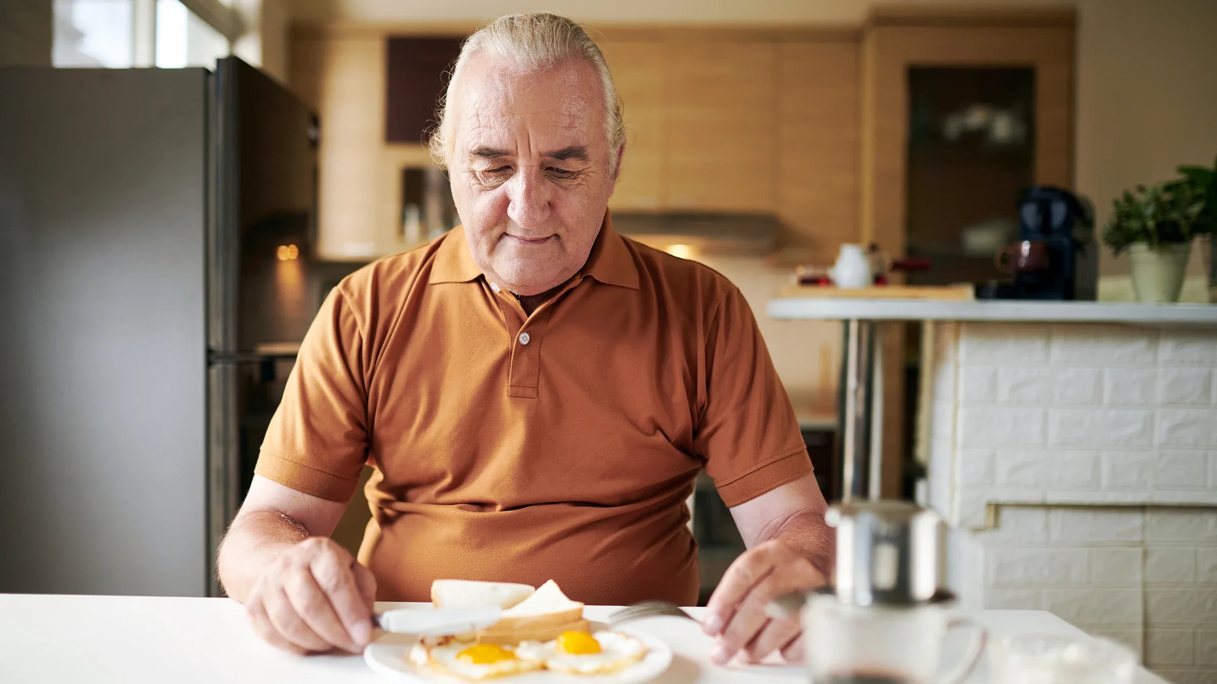 A man is preparing to eat breakfast at home.
DragonImages/iStock via Getty Images Plus