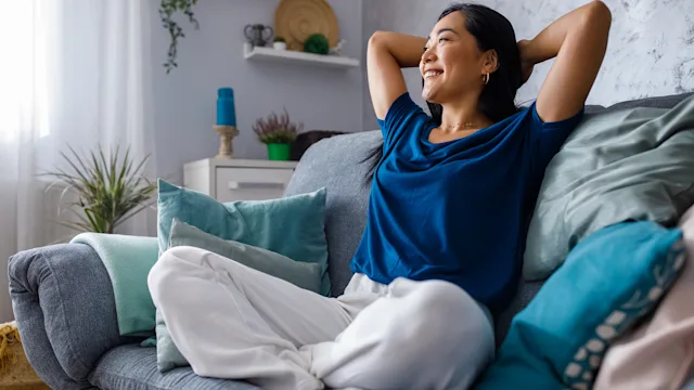 Mental health: woman relaxing on sofa 1353365157