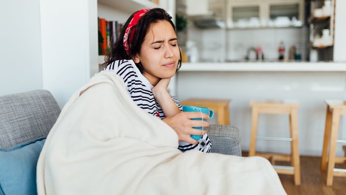 A Woman Sits On The Bed Beside A Face-down Man Coffee Mug by