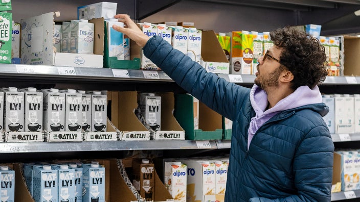 Man buying plant based milk.