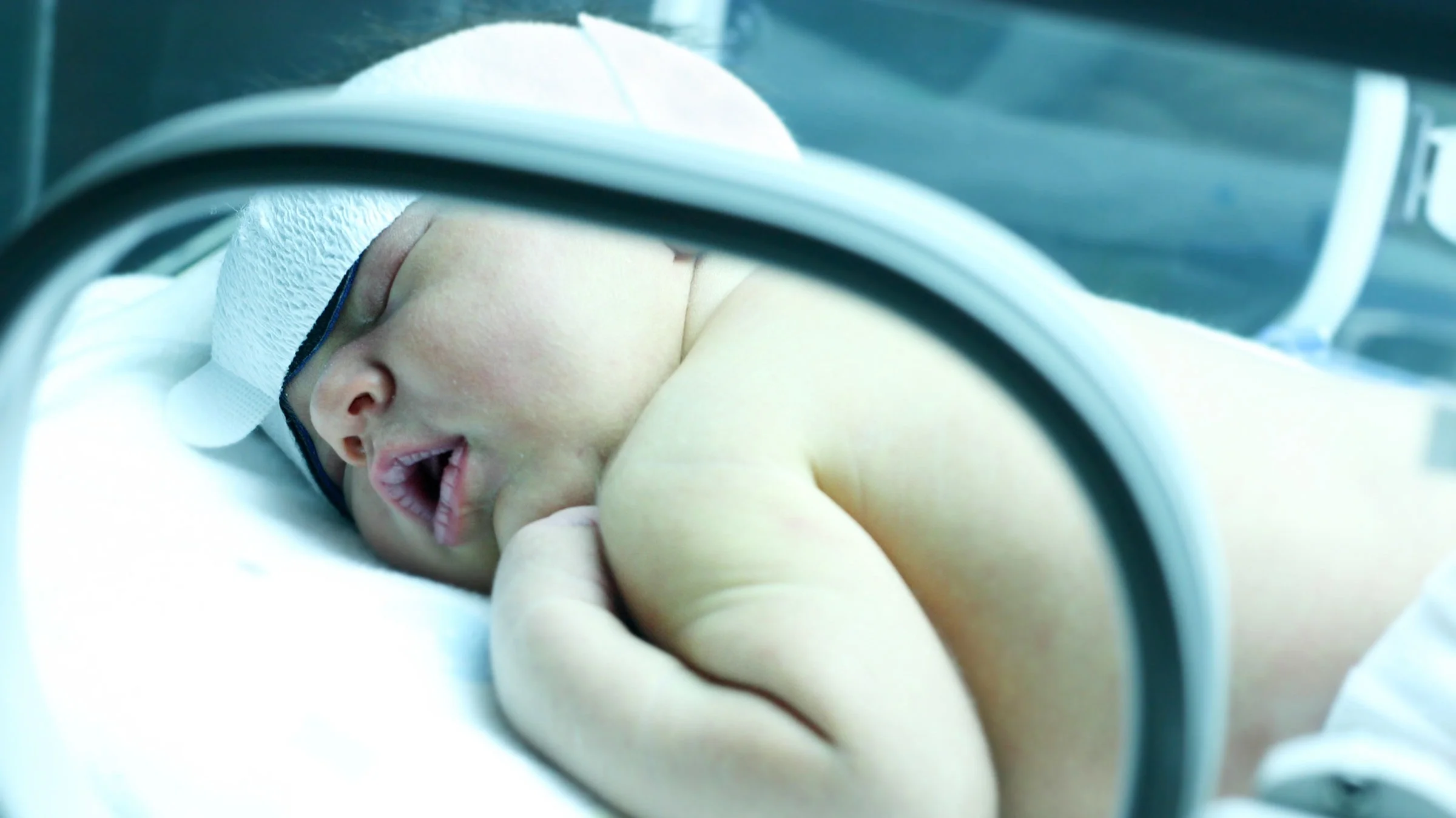 Baby with jaundice under uv lights at hospital.