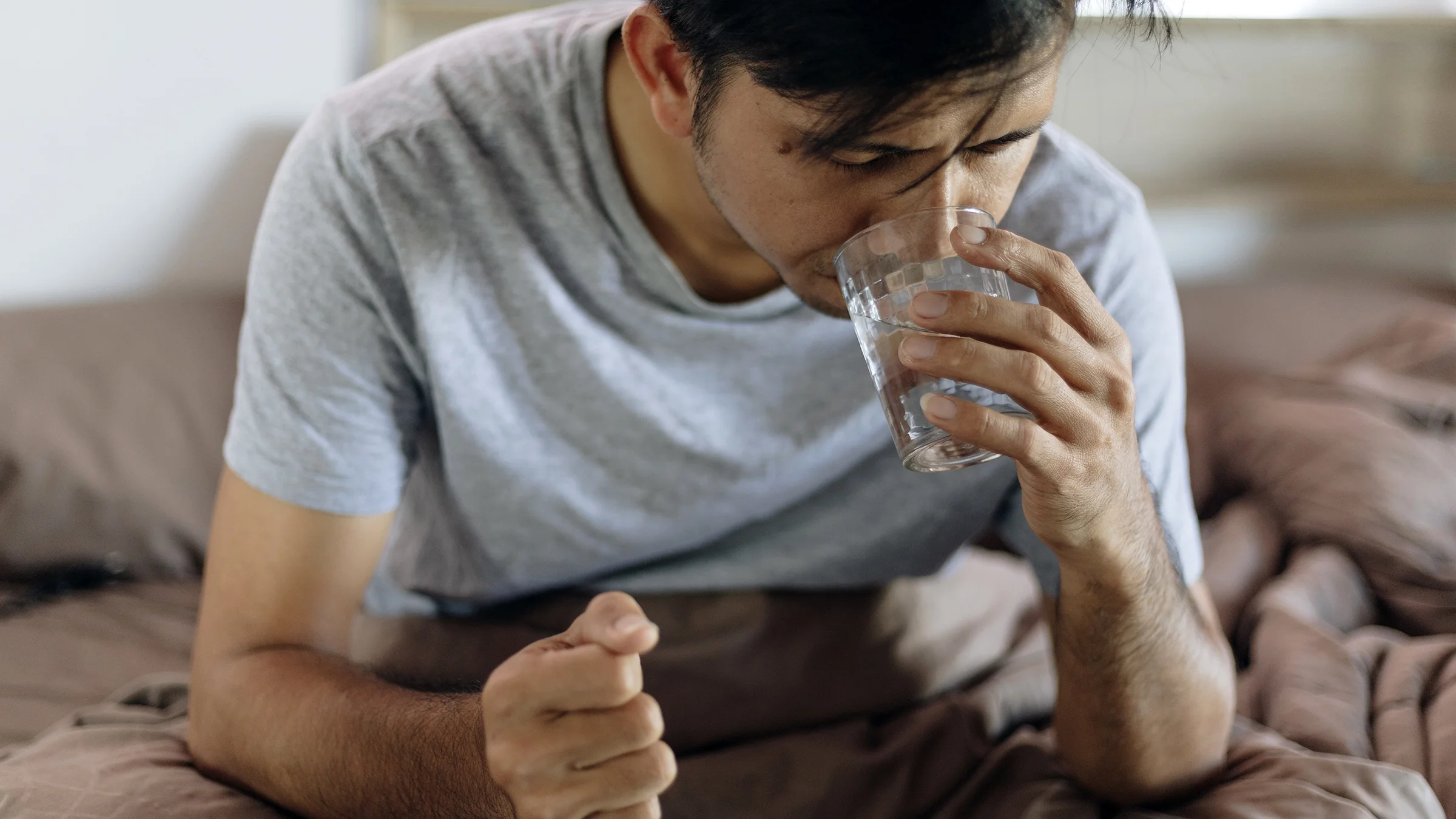 Man taking pill by mouth
