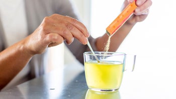 closeup mixing powder supplement into water 1238224318