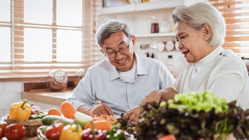 Health: High triglycerides: senior couple prepping dinner-1190205448