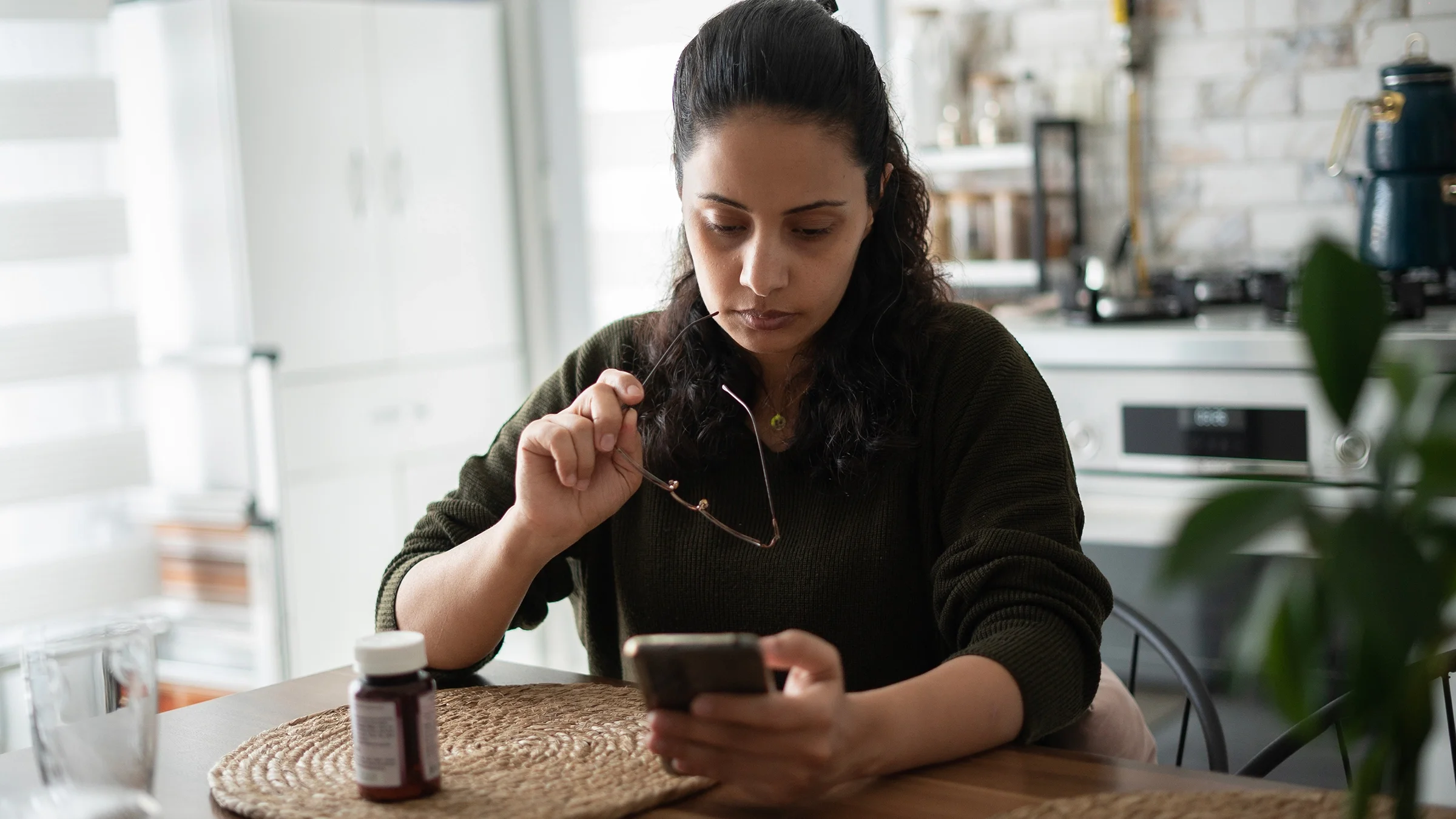 Woman researching medication on smartphone.