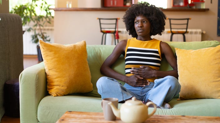 A person holding their abdomen.