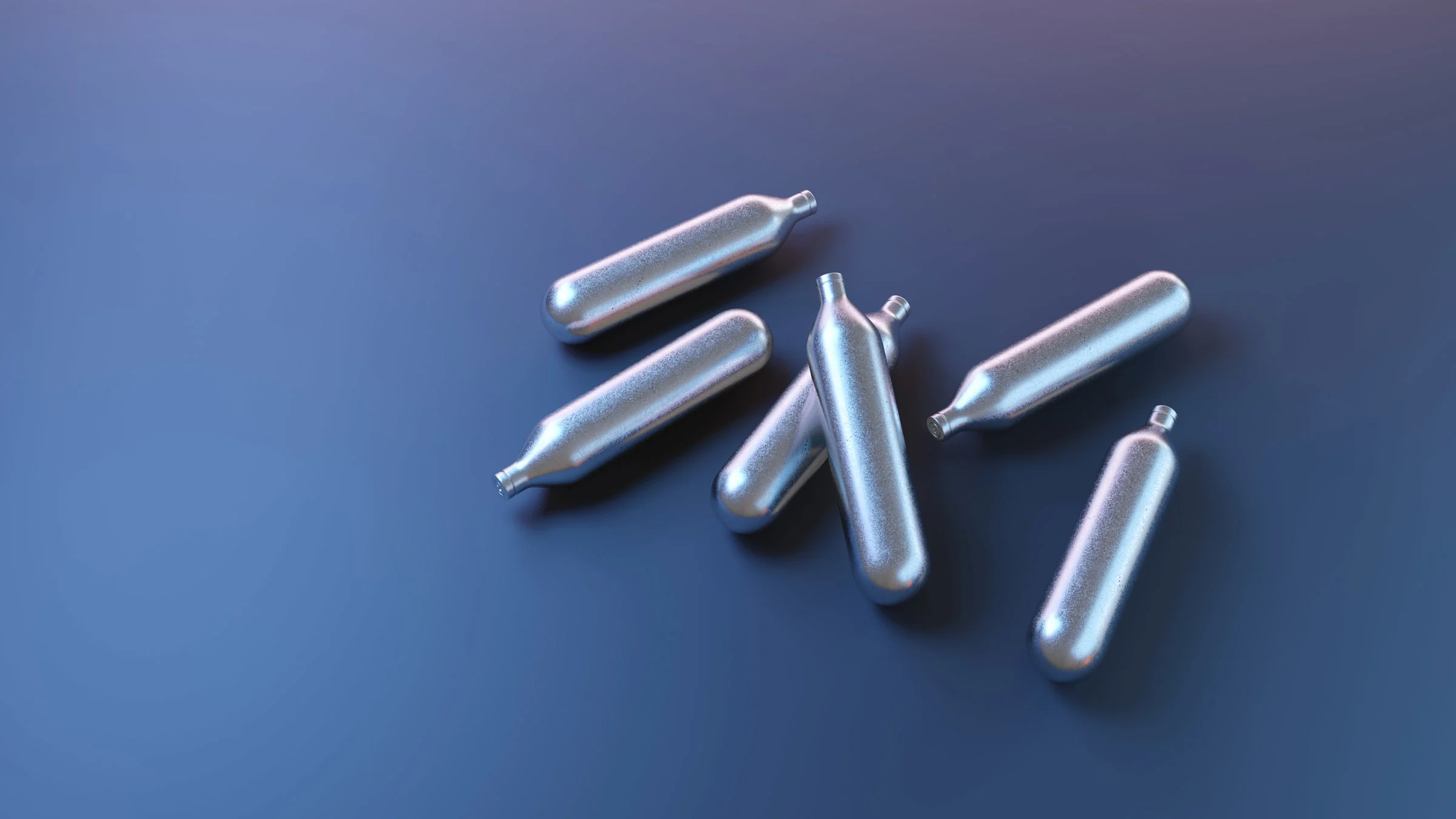 Nitrous oxide cartridges on a blue background.