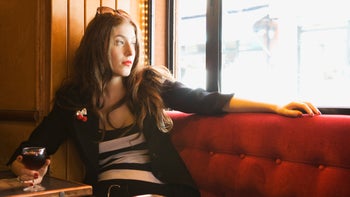 Alcohol: Stress: holding wine looking out bar window 85628594