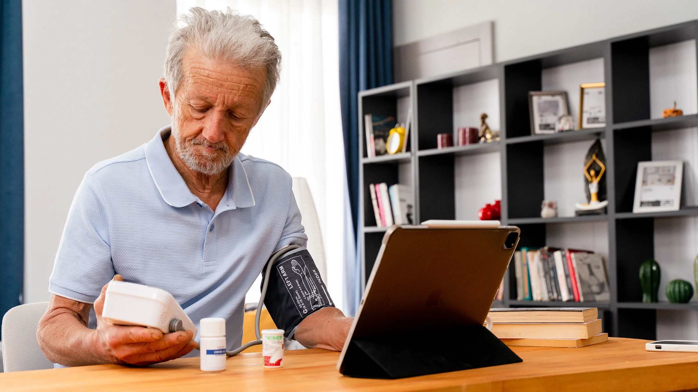 A man takes his blood pressure at home.