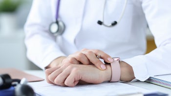 Health: providers: doctor checking watch closeup-1300457501