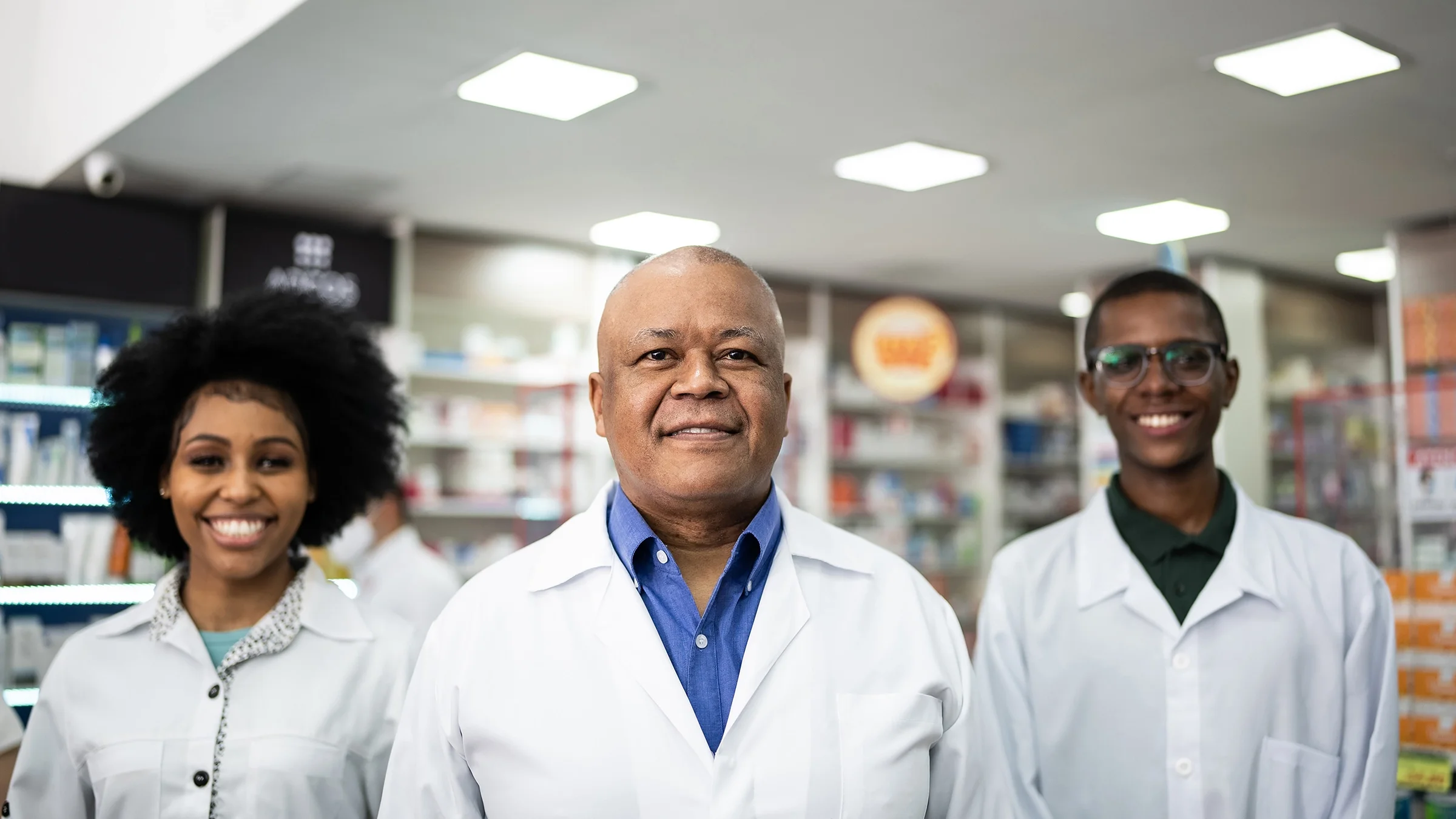 Portrait of three pharmacists in the backroom of the pharmacy.