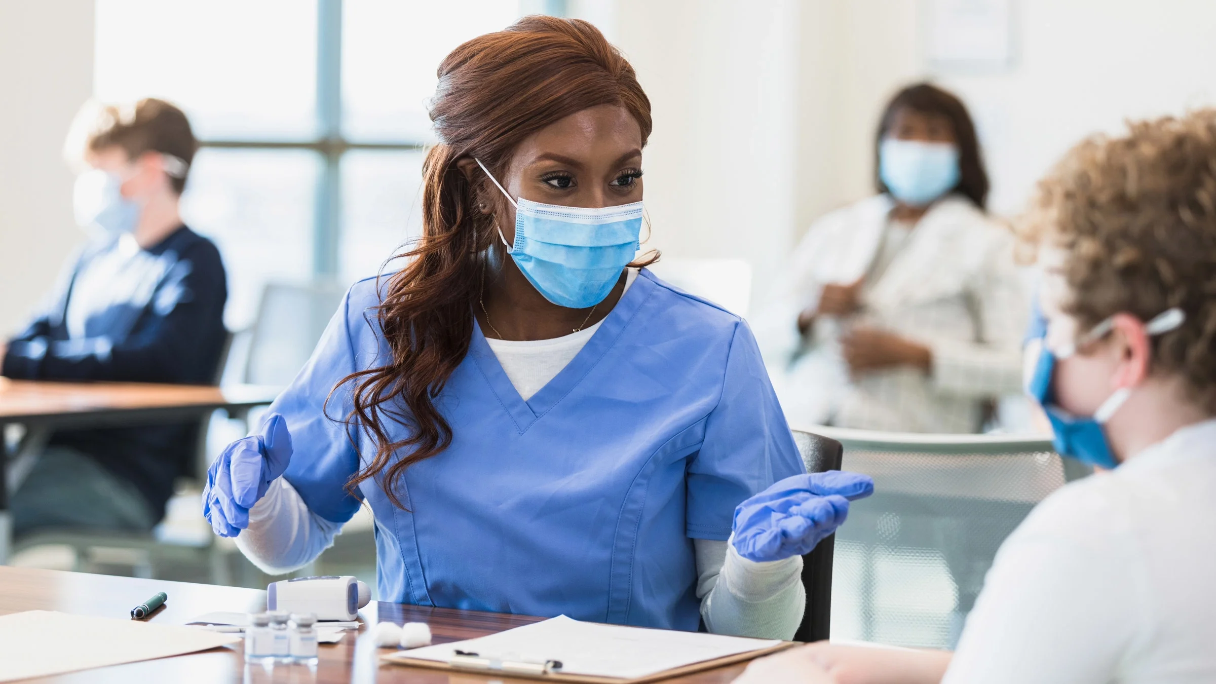 A nurse answering questions about vaccines.