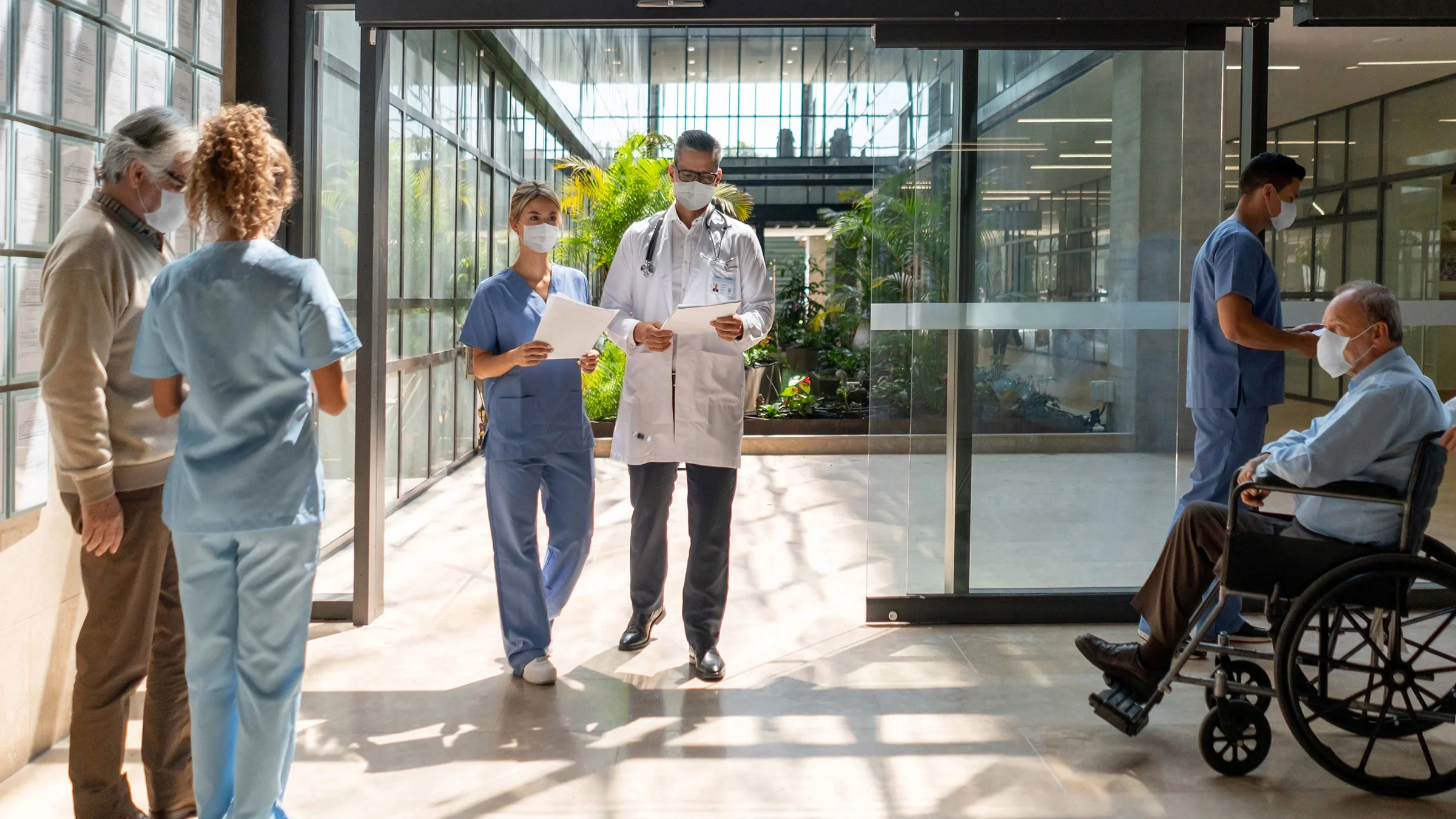 A hospital lobby is captured at a busy moment.