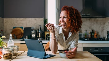 Diet and nutrition: woman enjoying breakfast 2151453420