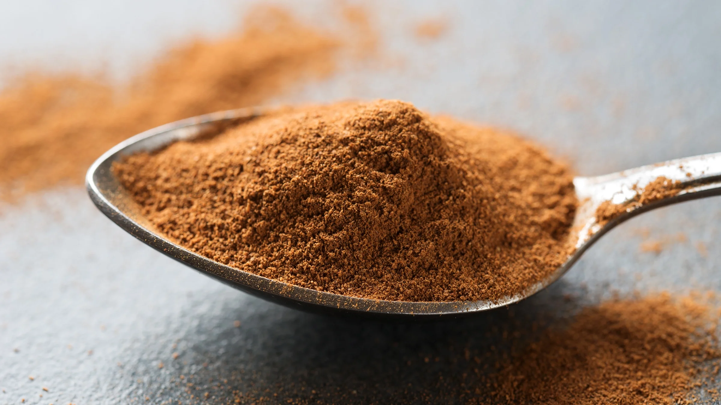 Close-up of a spoon full of cinnamon powder