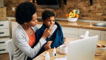 Health: Allergies: mother using nasal spray on child-1291295065