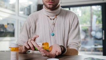 Prostate cancer: Corticosteroids: cropped pouring pills into hand 1438994895