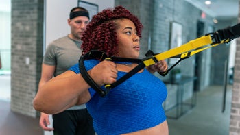 Movement-exercise: woman exercising with TRX suspension bands 1475425975