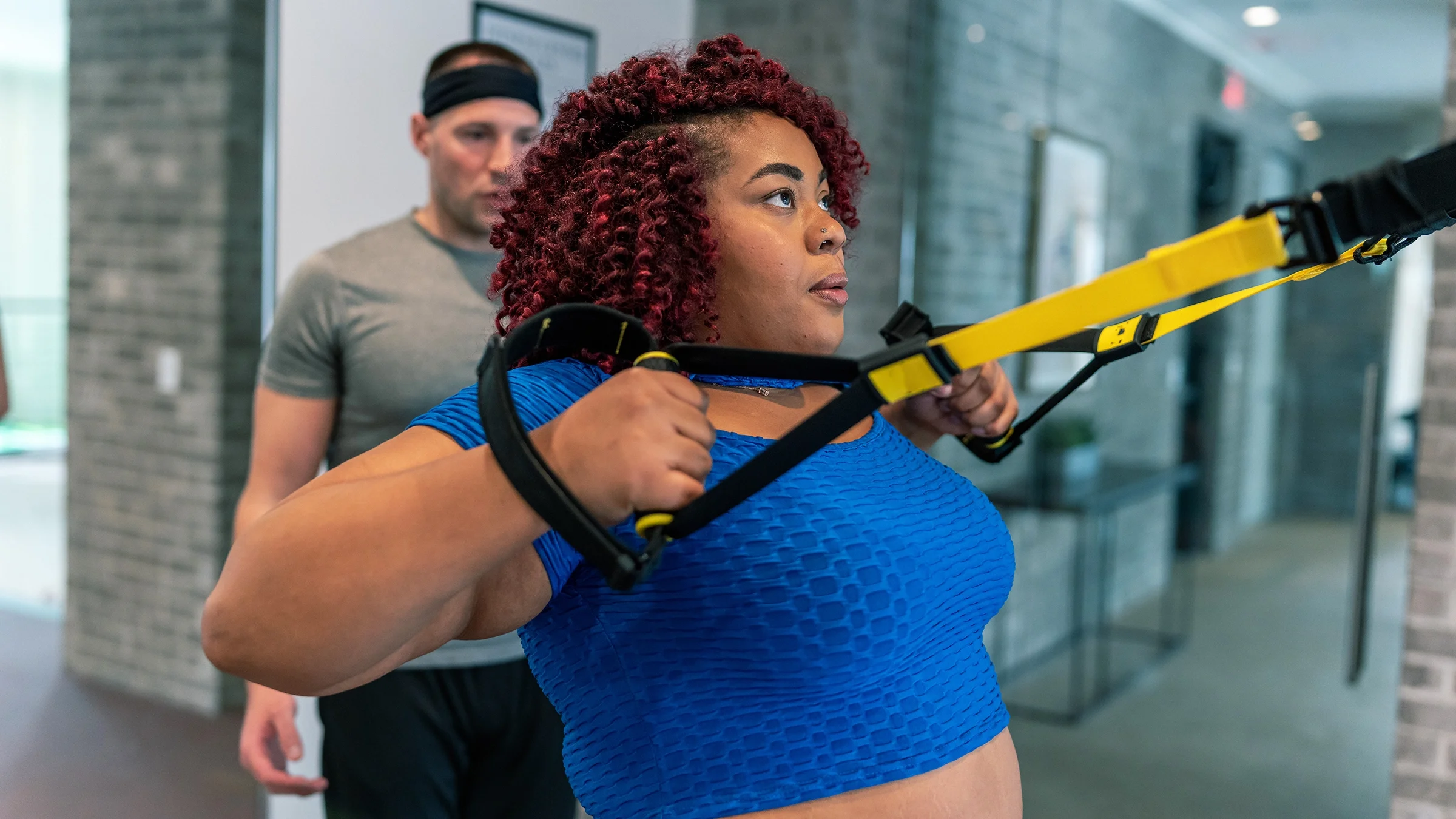 Woman exercising with TRX suspension bands