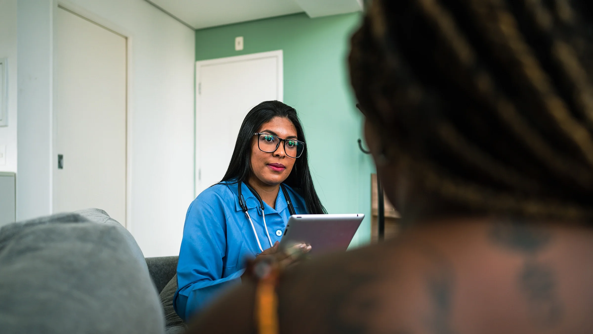 A healthcare professional speaks to a patient.