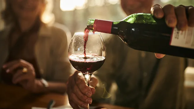 Diet Nutrition: closeup man pouring red wine 1457355349