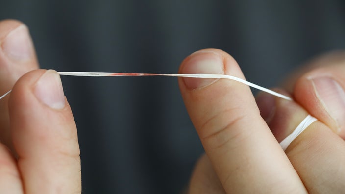 Close-up of dental floss with blood