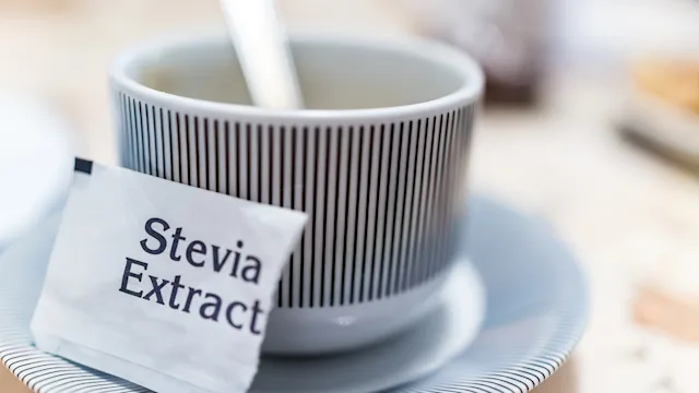 Diet-nutrition: closeup stevia packet with a mug 638304292