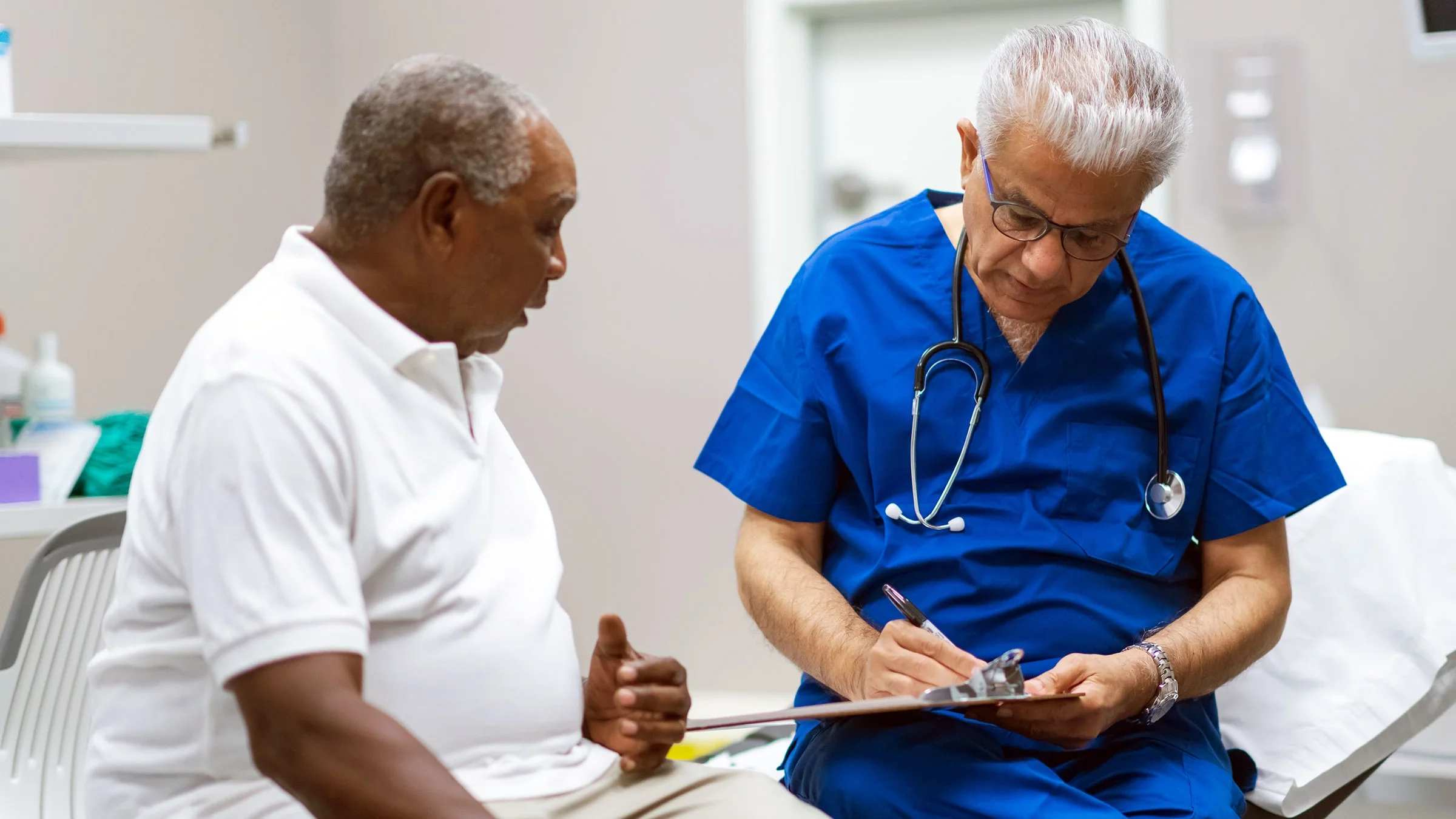 A man discusses his health goals with his doctor.