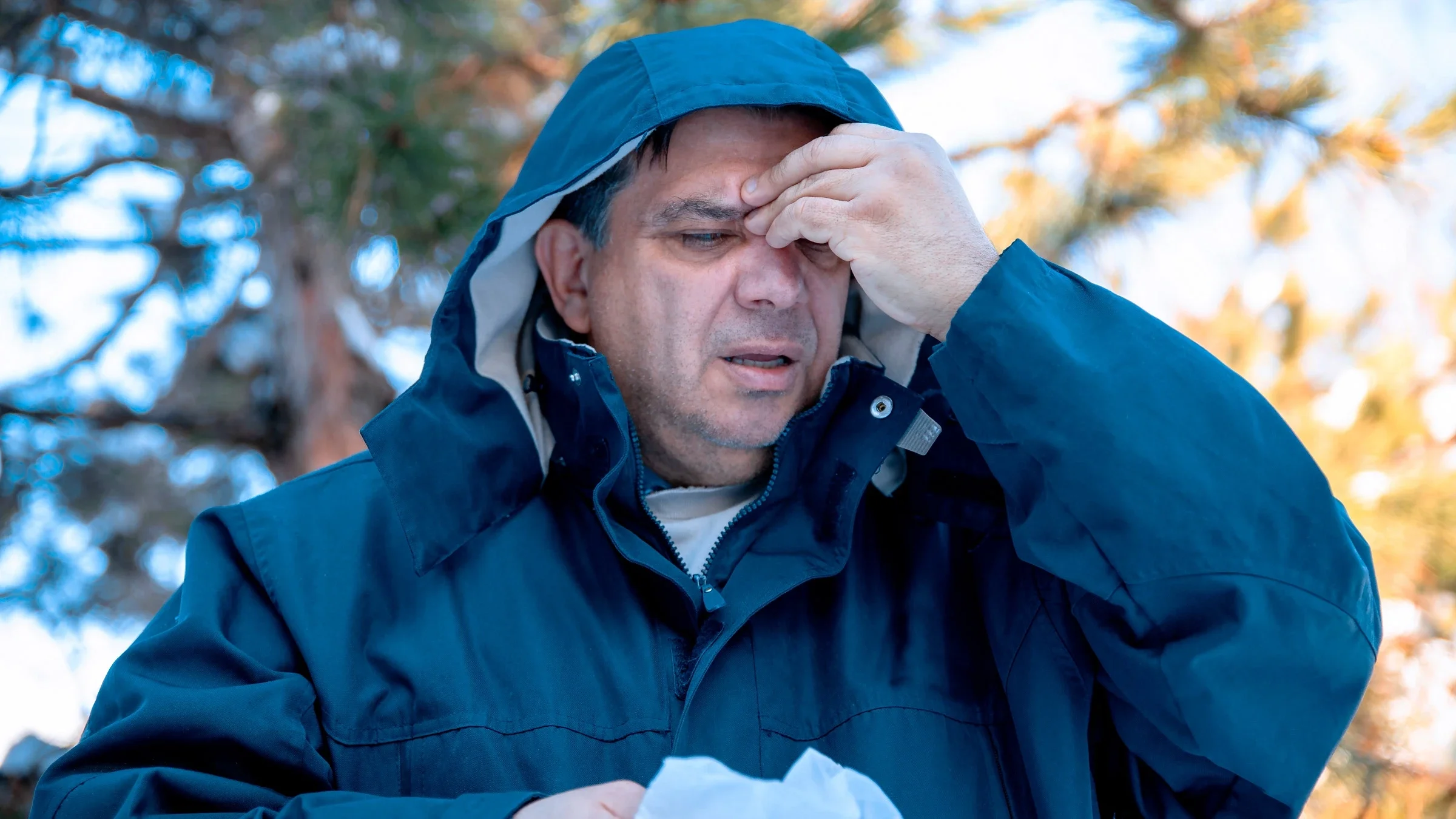 A person with a sinus headache outside.	