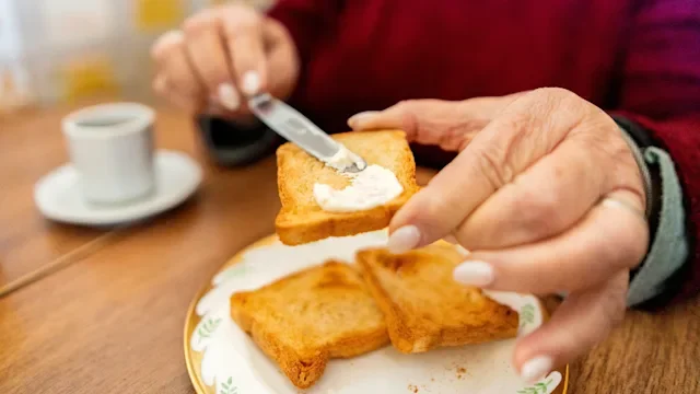 diet-nutrition: closeup butter on toast 2282606535