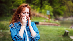 Woman uses a nasal spray while outdoors.
dragana991/iStock via Getty Images Plus