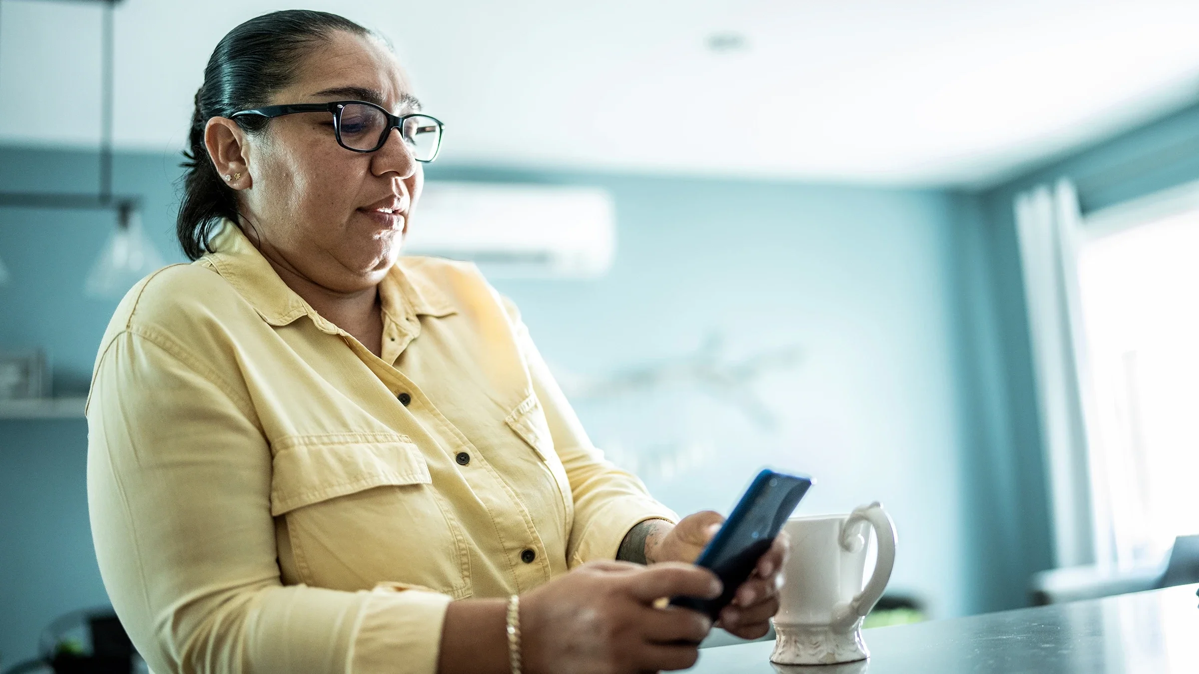 Woman using mobile phone at home