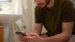 A cropped person using their phone while sitting on a toilet.
EXTREME-PHOTOGRAPHER/iStock via Getty Images Plus  
