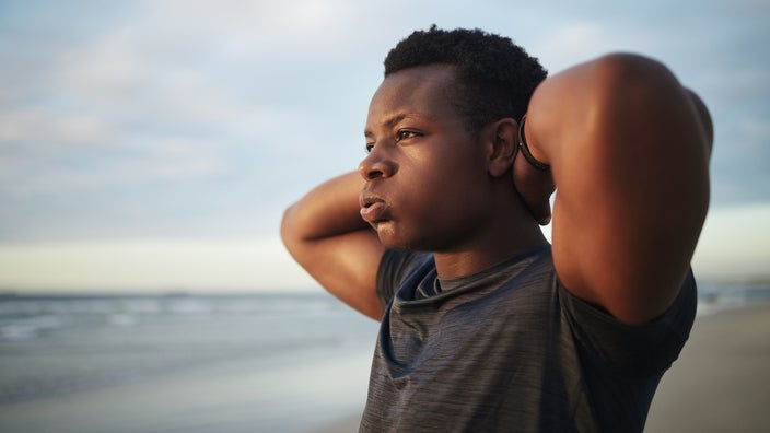 A man looks worried and anxious while at the beach.