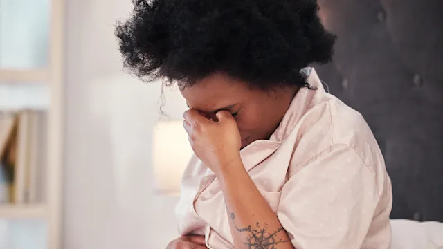 GLP 1 agonists: woman in bed with a migraine 1487504758