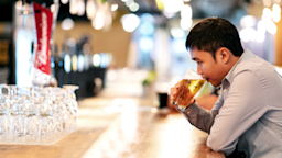 A man drinks beer alone at a bar.
ChayTee/iStock via Getty Images Plus