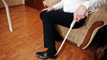 Joints: Senior: closeup man using shoe horn 1418183897